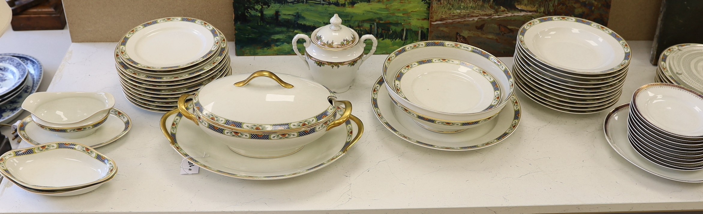 A Limoges gilt and floral decorated dinner service